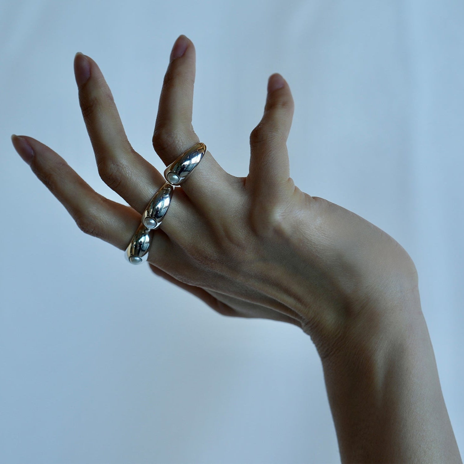 Model wearing a ring on each finger.
